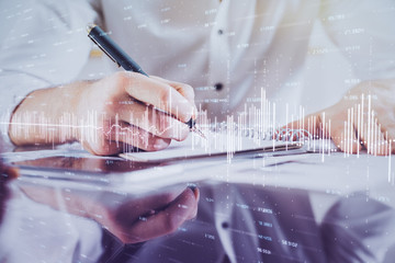 Multi exposure of man planing investment with stock market forex chart.