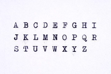 Obraz premium Alphabet written with an old typewriter. Letters isolated on white paper sheet