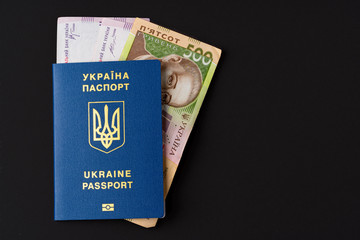 Ukrainian hryvnia banknotes in ukrainian passport close up