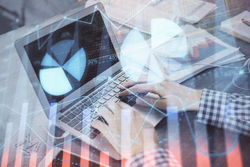 Double exposure of forex graph with man working on computer on background. Concept of market analysis.
