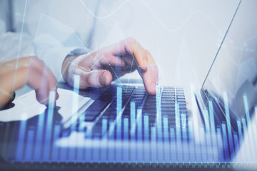 Double exposure of market chart with man working on computer on background. Concept of financial analysis.