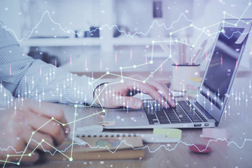 Multi exposure of stock market chart with man working on computer on background. Concept of financial analysis.