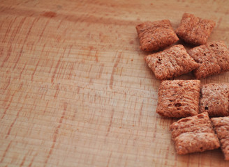 cereal pads in a row on a wooden board