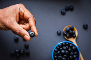 Closeup of blueberries on a dark blue background in a studio at day time