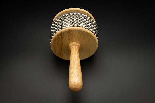 A cabasa in front of black background