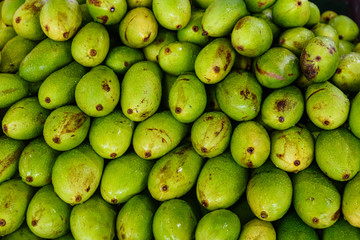 Pile of green mangoes, close up