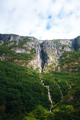 Norway landscape with big waterfall. Picturesque landscape mountains of Norway. Travelling, lifestyle, wild nature concept.