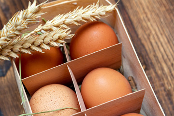 farm brown eggs with straw in birch bark box wooden background close-up