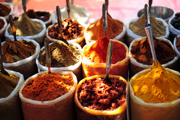 Variety of spices on the market in Asia. Powdered spices in bags, close-up. Turmeric, chili pepper, coriander, nutmeg, spices in eastern bazaar.