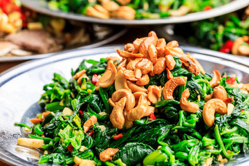 Delicious spinach cold dish,the ingredients are chili and garlic with cashews.Chinese food.