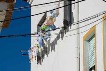 Laundry hanging on the clothesline outside on a balcony in Nazare, Portugal