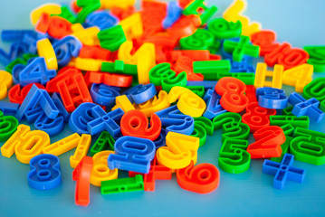 Fototapeta na wymiar Multicolored plastic figures, educational skills supplement for kindergarten and preschool children.