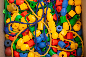 Multicolored plastic beads and rope learning tools for young children