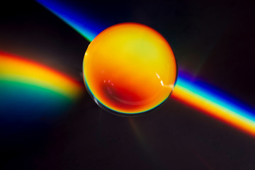 Rainbow prism effect conceptual photo of a glass ball