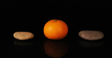 Tangerine between two stones. Spa concept