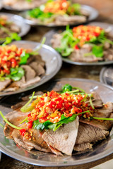 Delicious dried beef slices cold dish,the ingredients are red pepper and garlic with coriander.Chinese food.