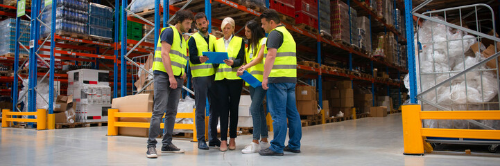 Warehouse staff meeting, workers with mnagers