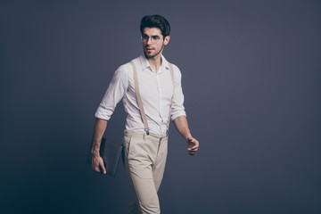 Profile side photo of gorgeous minded guy go work start-up hold computer ready decide solution wear stylish outfit isolated over grey color background