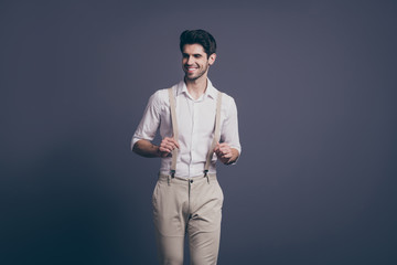 Portrait of cheerful macho man have free time walk look good touch suspenders attract girls wear...