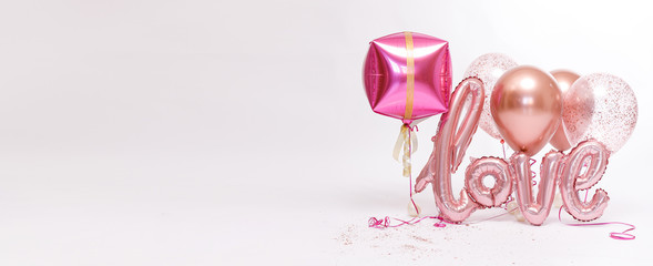 Fototapeta premium Stylish metallic pink balloons for Valentine's day, hen party or baby shower on a white background. The inscription 