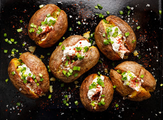Baked potato, baked potatoes stuffed with butter, cream cheese and green onions, seasoned with...