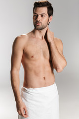 Photo of athletic half-naked man posing and looking