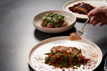 Set of various plates of food on a gray table background with copy space