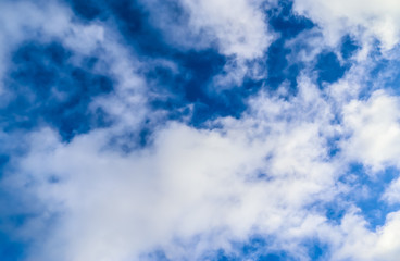 Beautiful view on white fluffy clouds in a deep blue sky