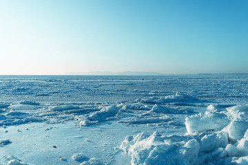 Naklejka na ściany i meble Ice blocks on the background of the frozen sea