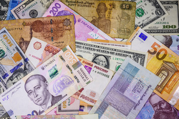 Multi currency background. Euro, american dollars, ukrainian hryvnias, egyptian pounds, russian roubles