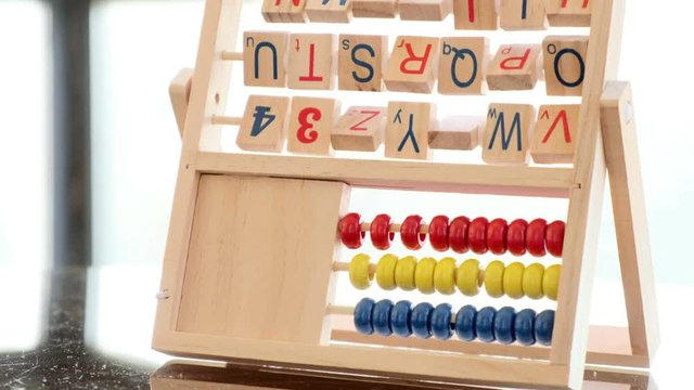  an alphabet abacus toy on bright, light background