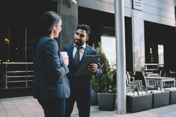 Colleagues speaking with each other in city