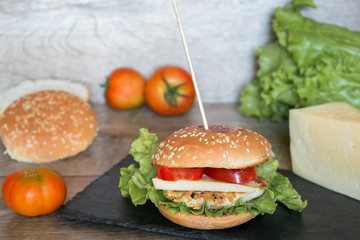 American cheeseburger with fresh meat, and cheese on a table.