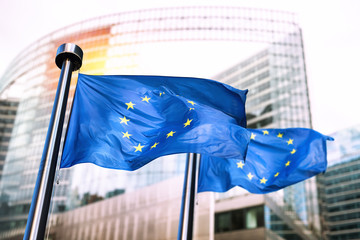 European Union flags waving in front of European Commission. - obrazy, fototapety, plakaty