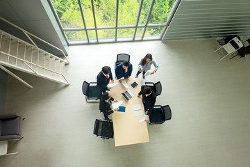 Top view on a group of businessman and businesswoman having a meeting and making a business...