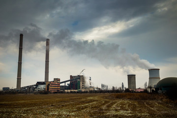 Fototapeta na wymiar Dirty smoke from industrial chimneys or factory pipes in old factory. Big impact on climate change.