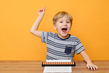 Little boy doing simple math exercises with abacus scores. Mental arithmeric.