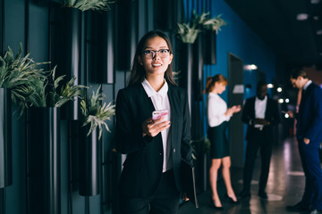 Asian businesswoman using cellphone at workplace