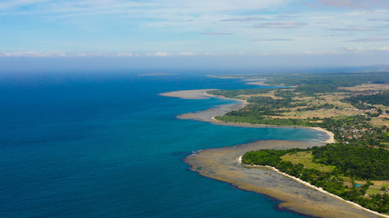 Luzon Island, Philippines. Seascape, lagoons with coral reefs, top view. Rice fields and villages on the island. Summer and travel vacation concept.