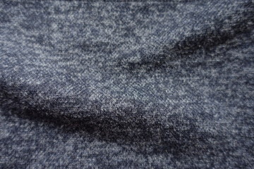 Closeup of dark heather blue woolen fabric in soft folds