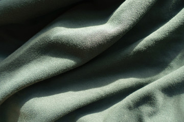 Simple dark green jersey fabric in soft folds