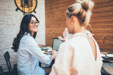 Young cheerful coworkers solving working problems