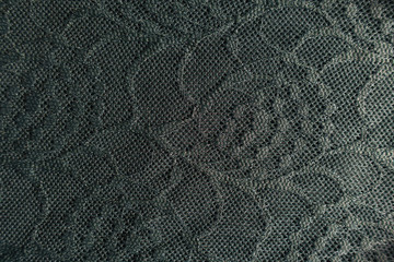 Top view of dark green lace with floral pattern
