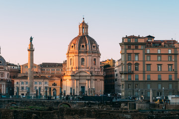 Rome, Italy - Jan 1, 2020: View across the ancient ruins of Trajan's Forum towards Trajan's Column and the Santa Maria di Loreto church in Rome, Italy