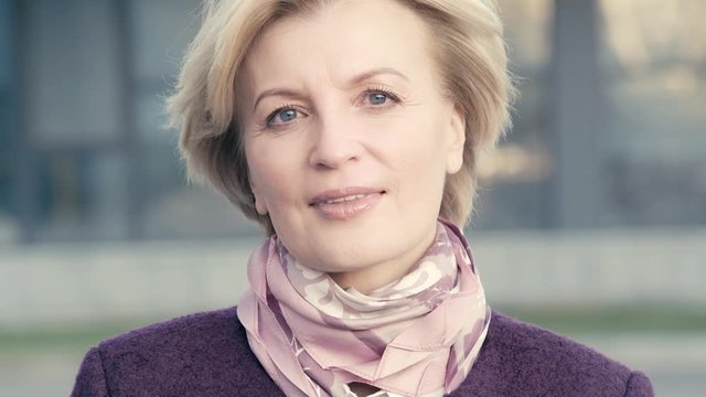 mature woman in scarf looking at camera 