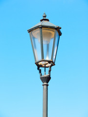 Fototapeta na wymiar Old street lamp in Prague. Detailed view with blue sky background