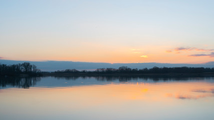 Fototapeta na wymiar sunset over the river in winter