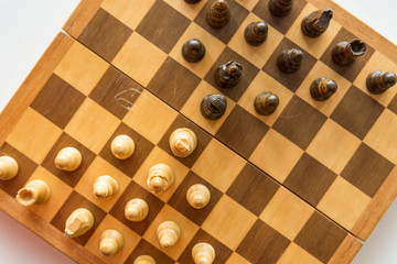 Drop down view of a chess board with wooden figures.