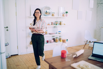 Pretty women with plates going to kitchen table