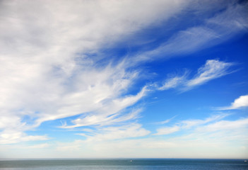 Naklejka na ściany i meble Beautiful cloudy sky with deep blue sea